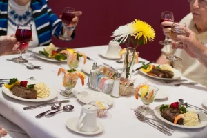 Senior citizens enjoying a gourmet meal at Garden Villas of Lenexa. Myths About Senior Living.